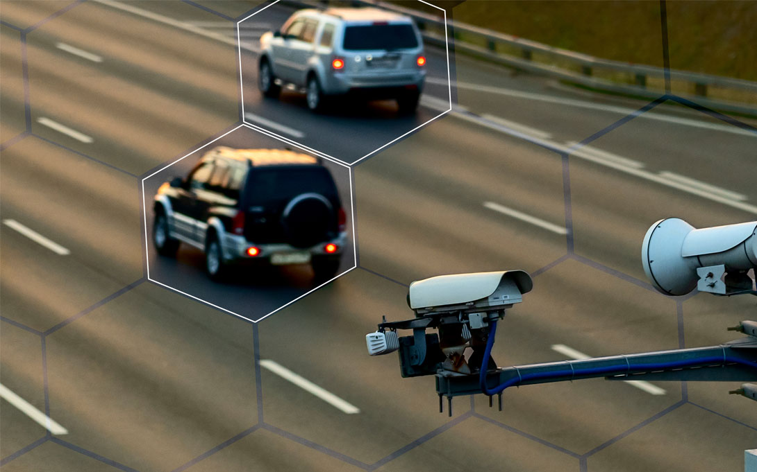 Surveillance cameras tracking cars on the freeway. 