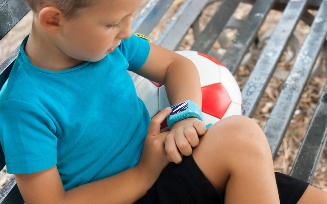 boy looking at smartwatch