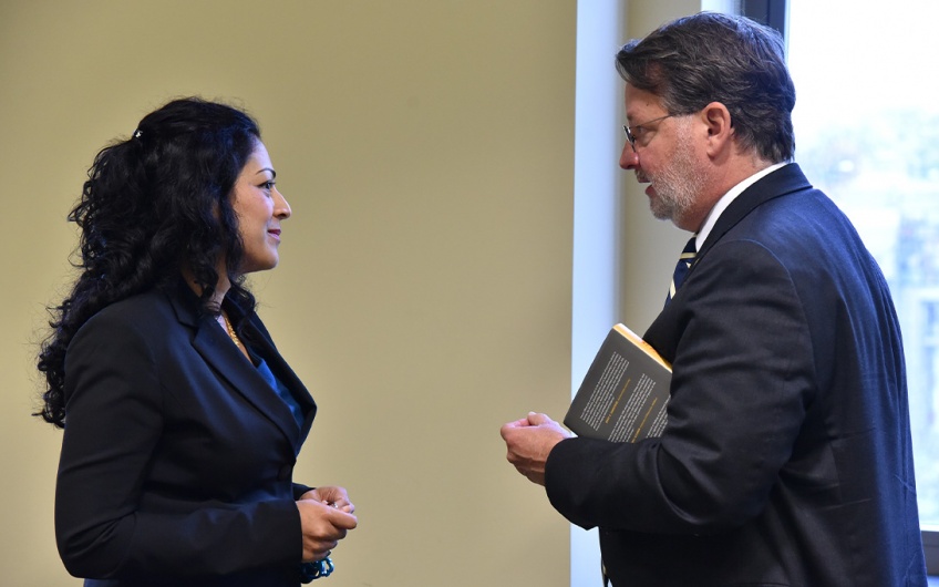 Professor Shobita Parthasarathy speaks with U.S. Senator Gary Peters (D-MI) at the Ford School