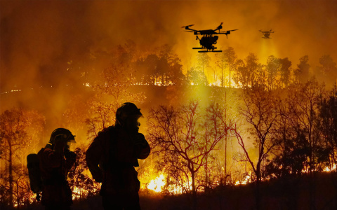 Photo of firefighting drones over a forest fire